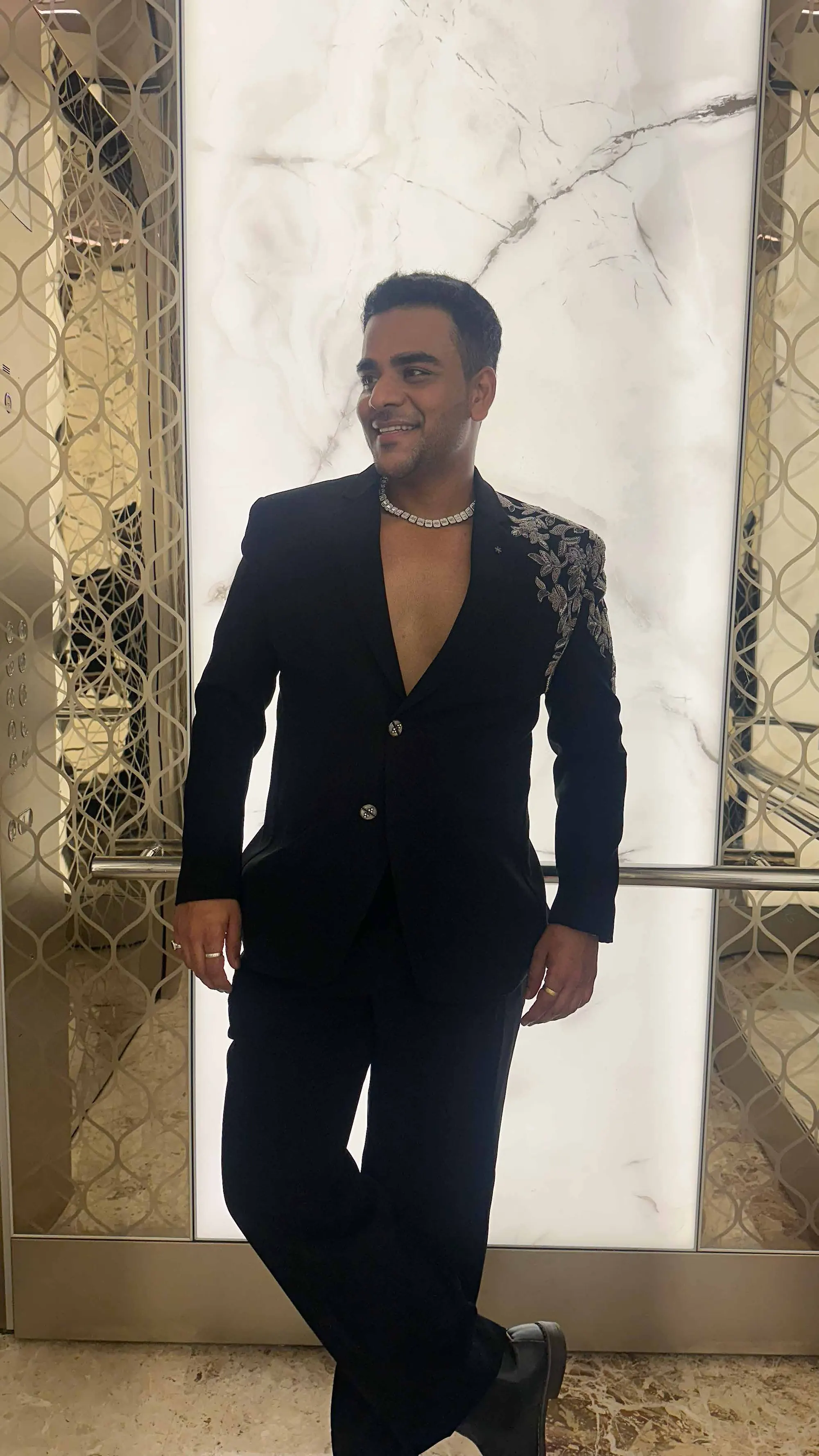 Portrait of Chirag Vithalani in a black embellished jacket against marble